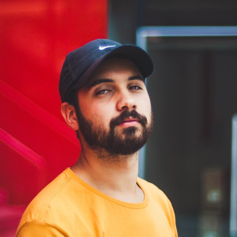 selective focus photography of man wearing Nike dad hat